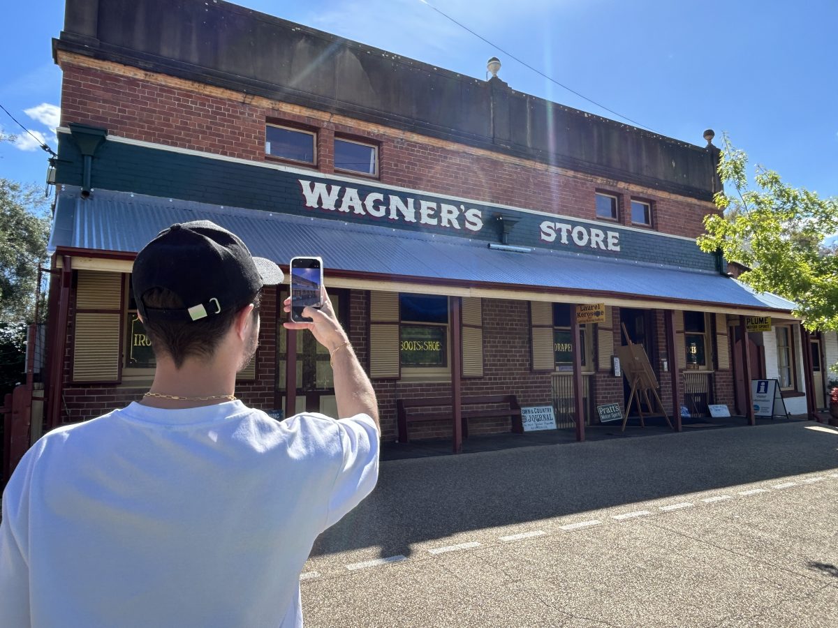 man photographing an old building