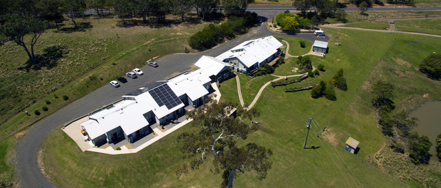 aerial view of a group of buildings surrounded by lawns