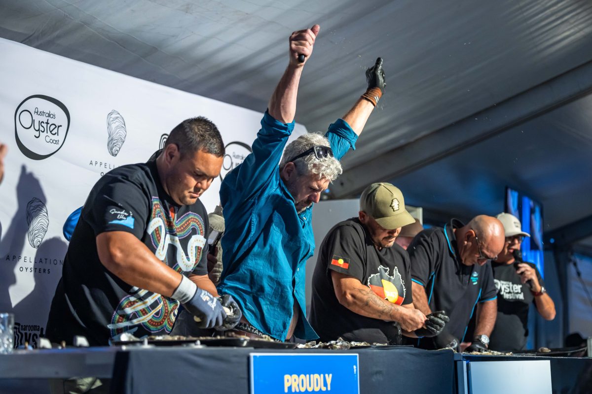 A man declaring victory in an oyster-shucking contest