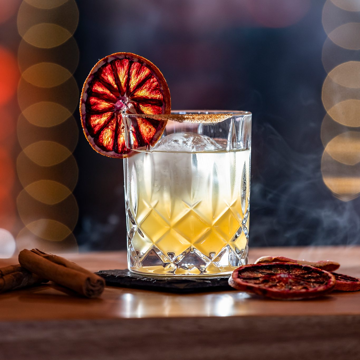 A cocktail with orange slice garnish.