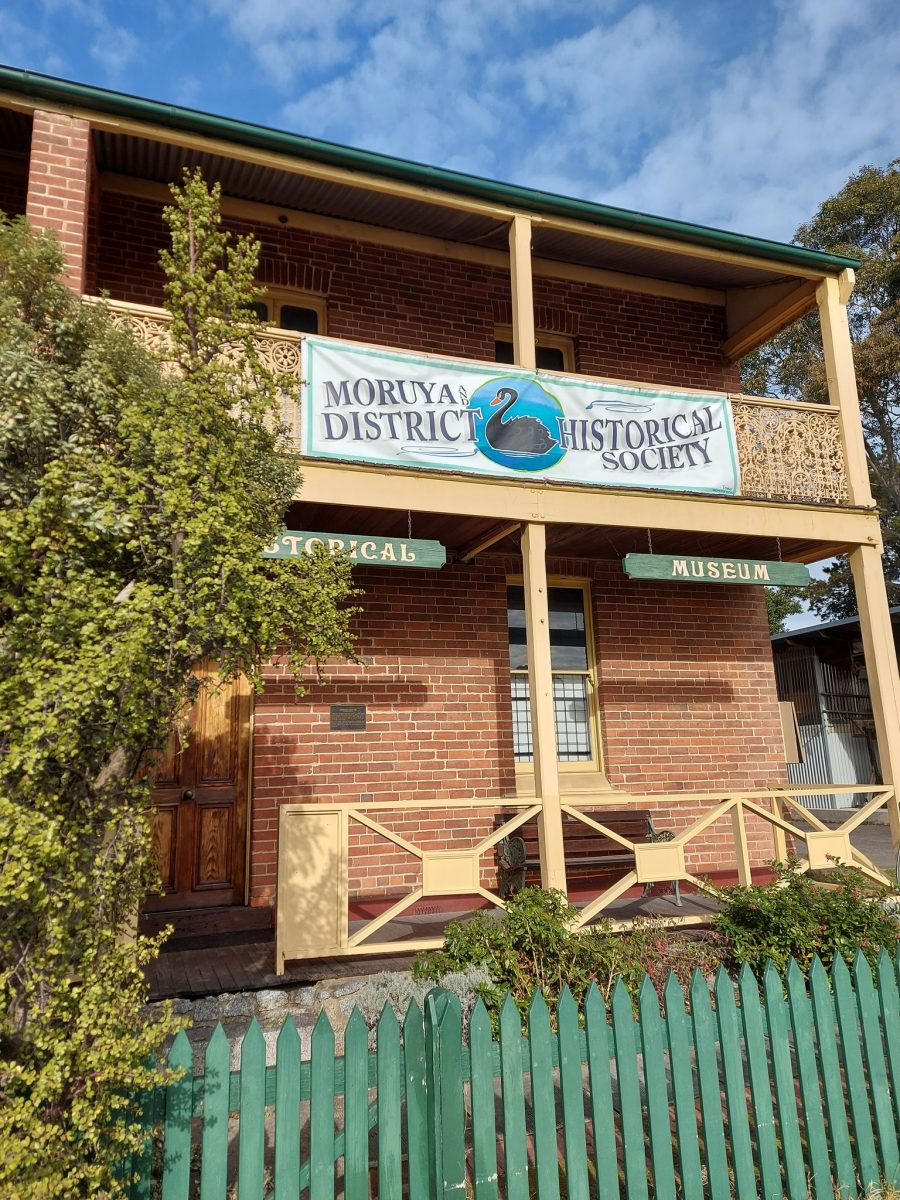 The outside of a brick two-storey building with a veranda