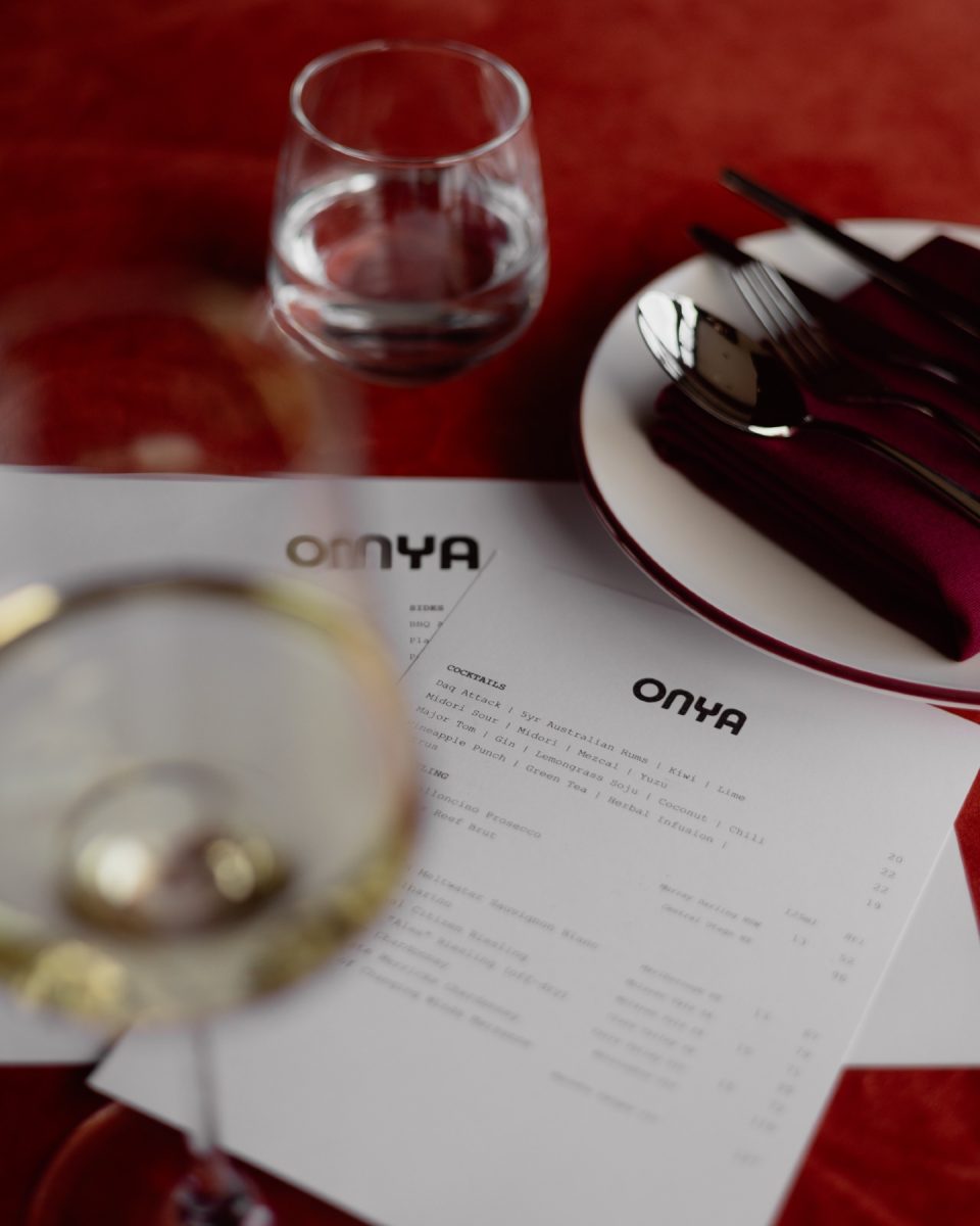Onya menus viewed through a wine glass.