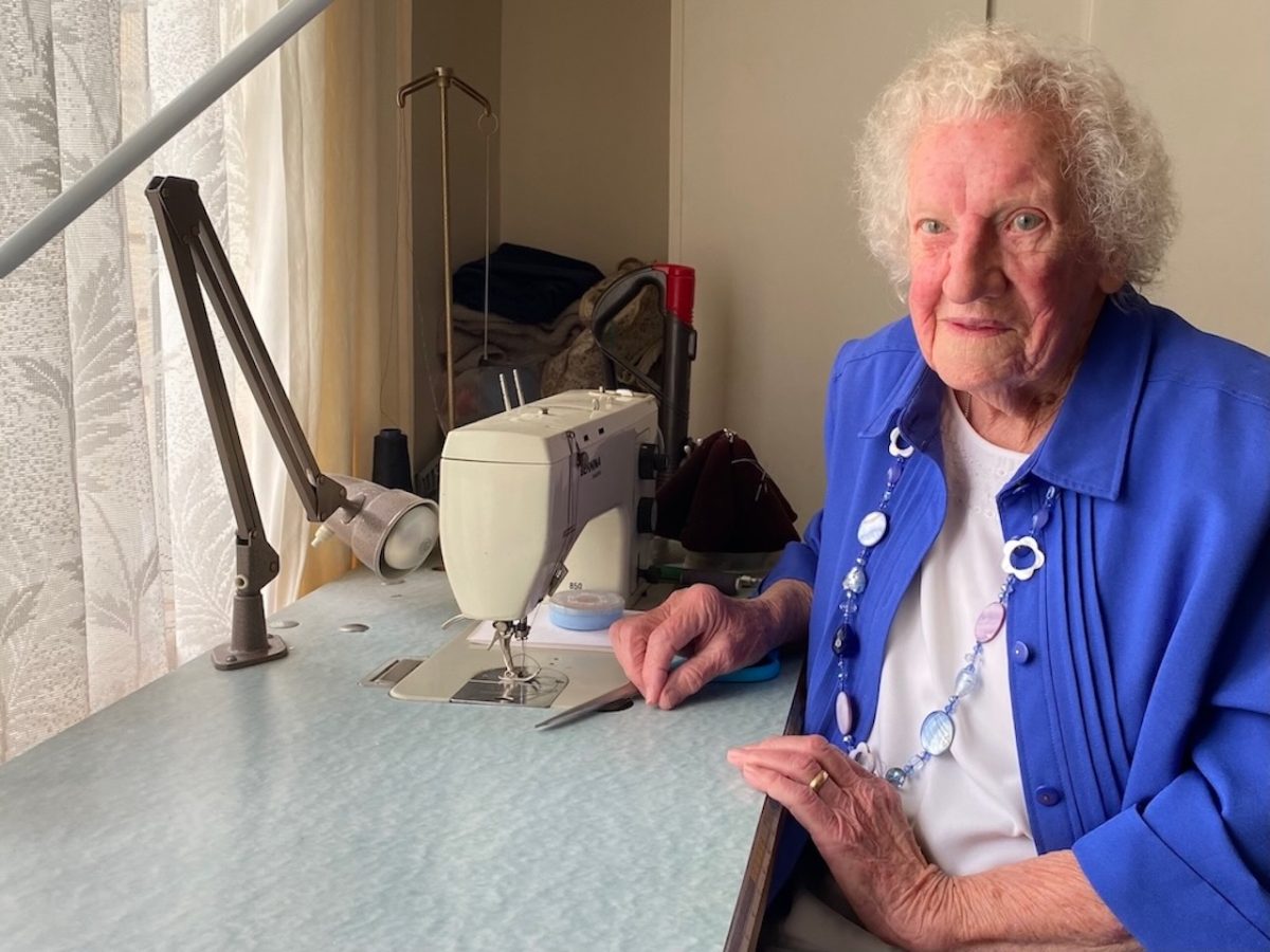elderly woman with a sewing machine