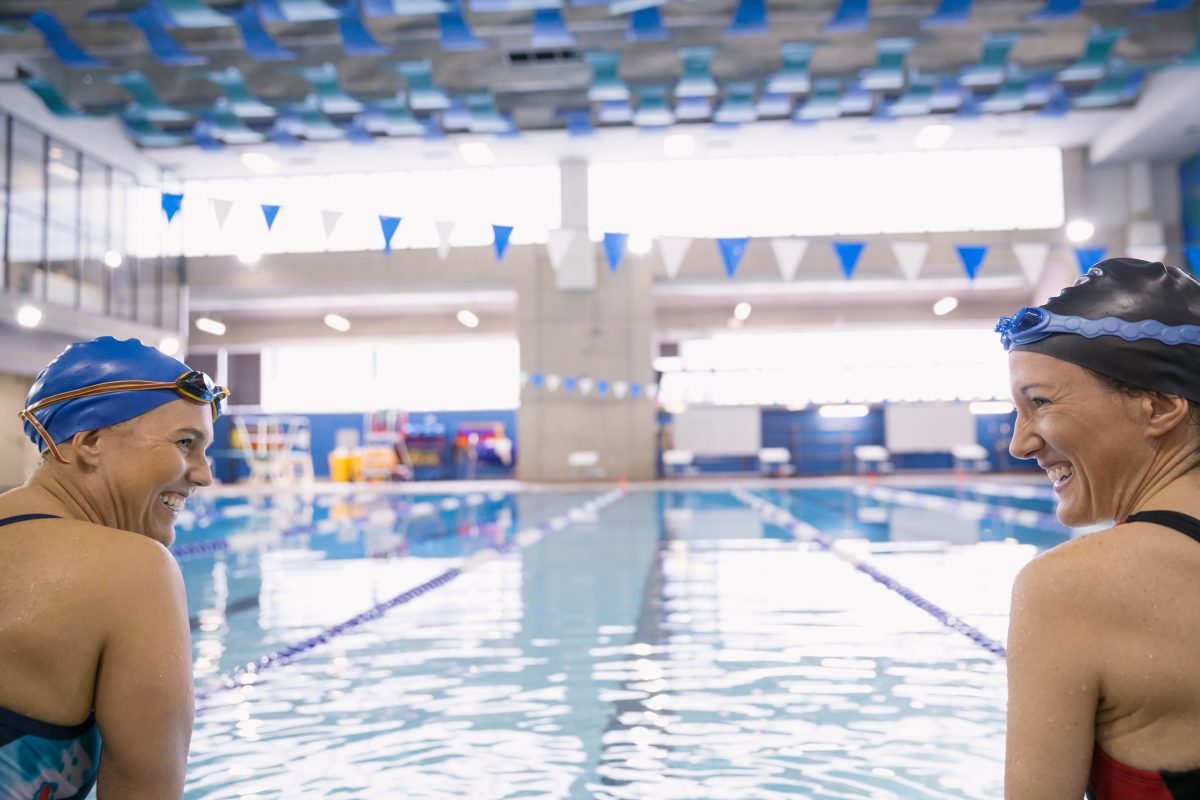 two smiling women in an indoor pool