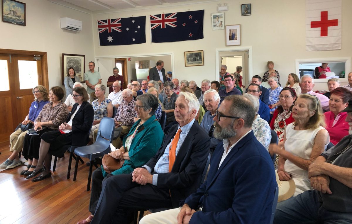 group of people at a meeting in a hall