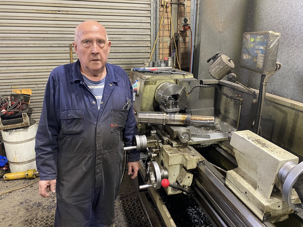 man in his engineering firm's workshop
