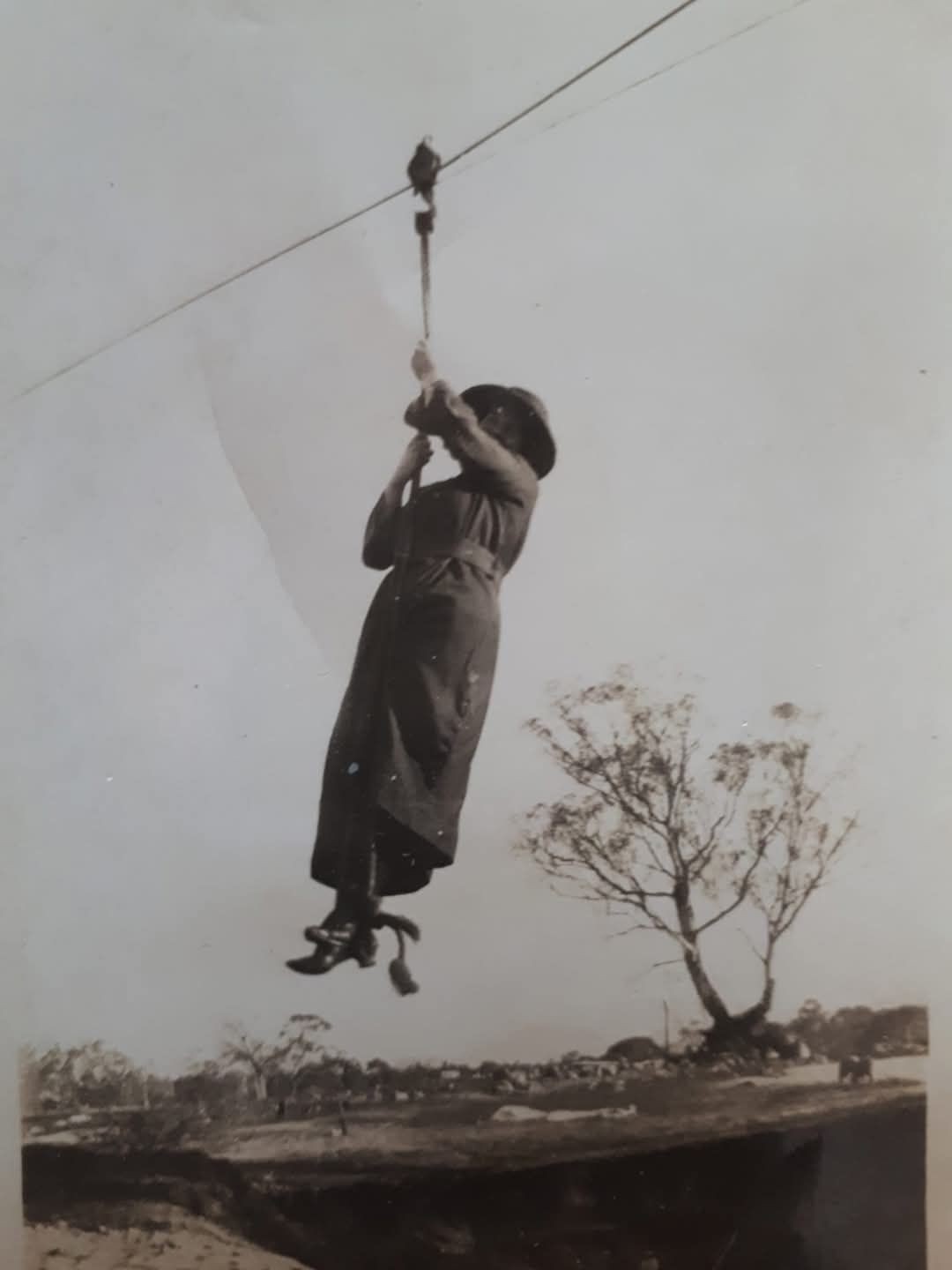 Historical photo of woman on a flying fox.