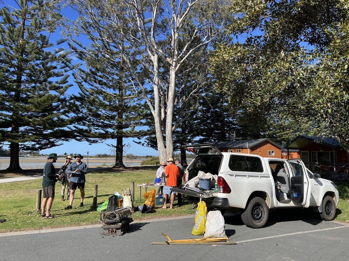 People standing around a white ute