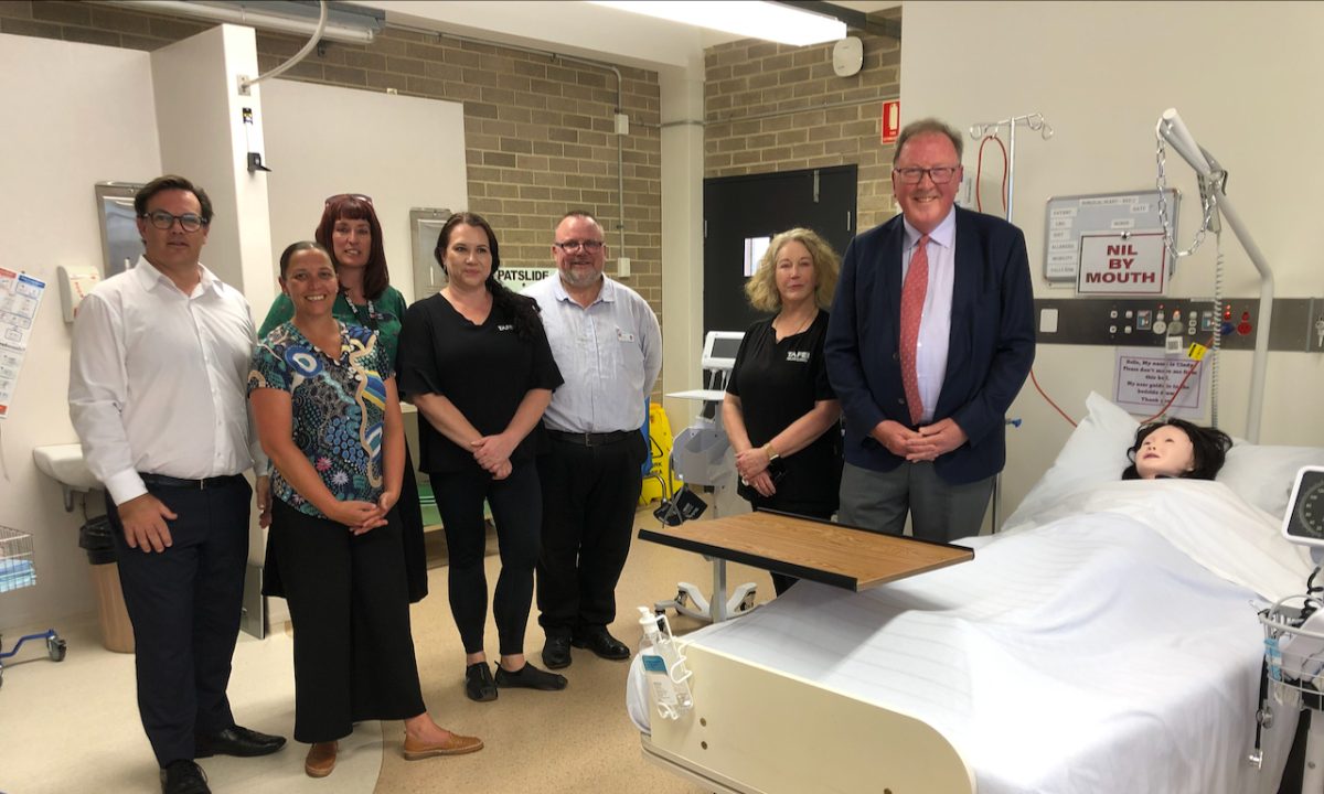 Dr Michael Holland with NSW TAFE Moruya staff in the old facilities for teaching nursing.