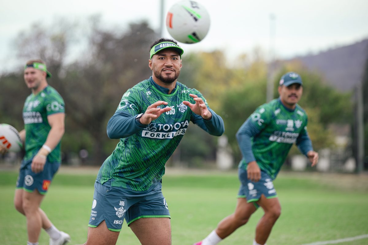 A rugby league player catching a ball during training