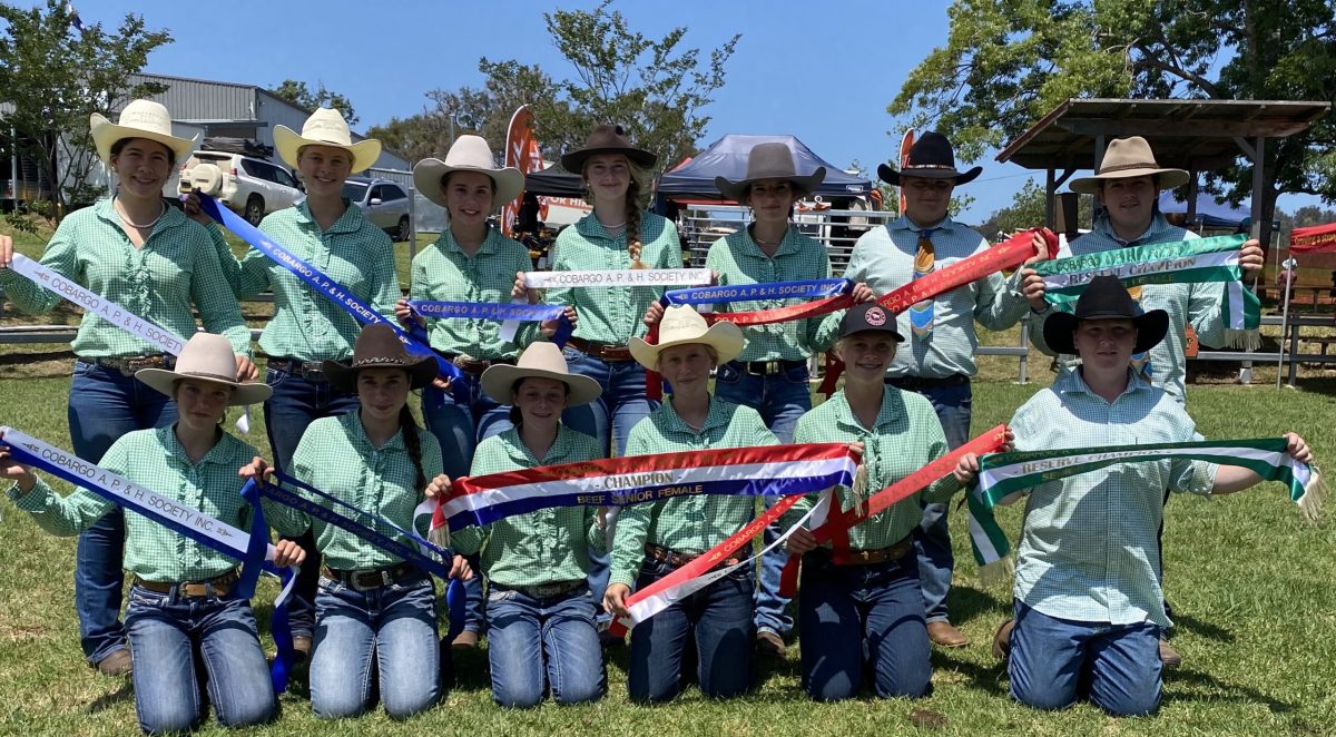Students from Narooma High School with some of the prize ribbons the school's cattle have won.