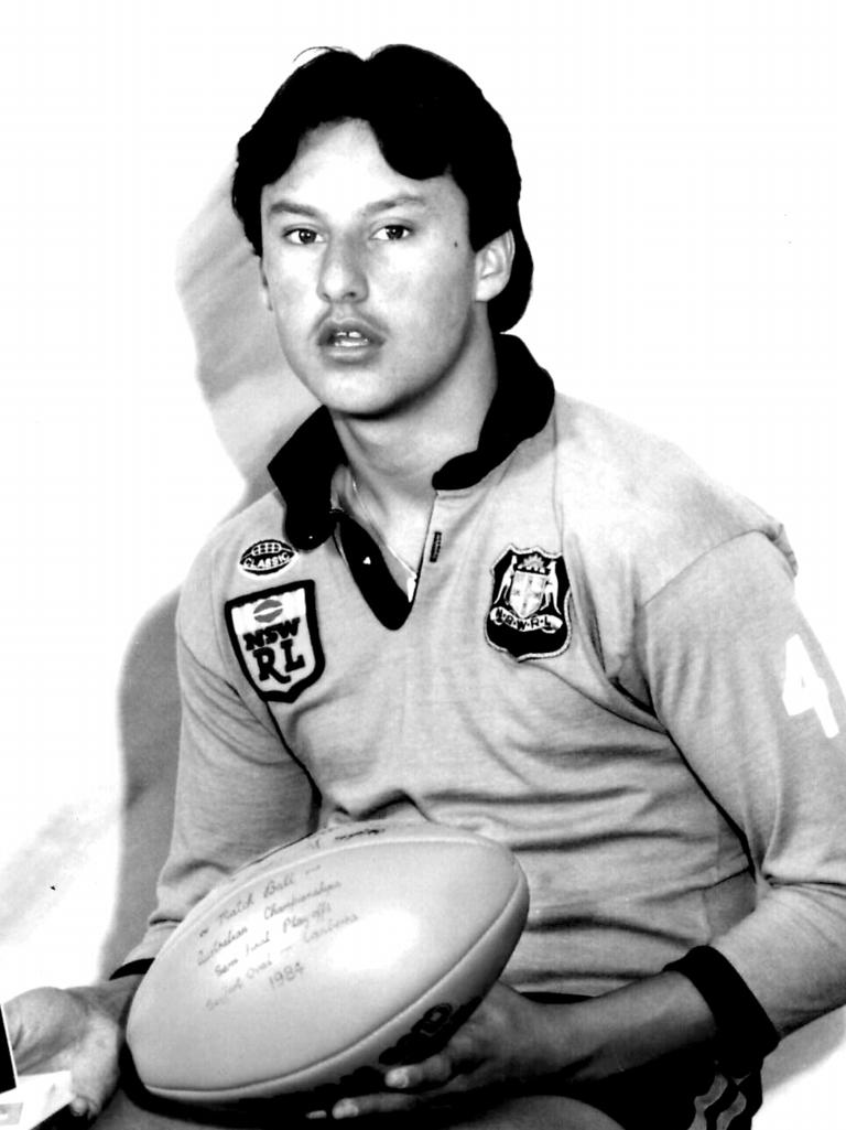 A young Laurie Daley with a football