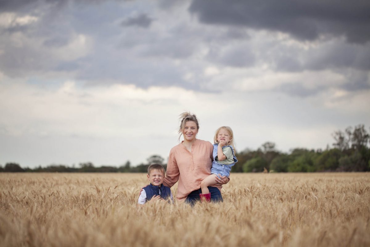 Sarah Armstrong in a field with her two kids. 