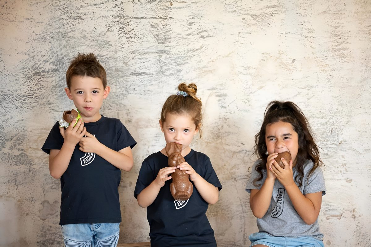 Three kids eating Easter eggs