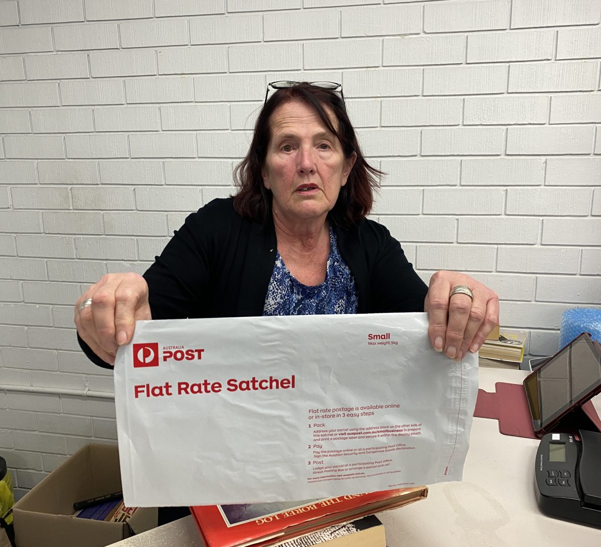 Carol Rose holds up postage pack 