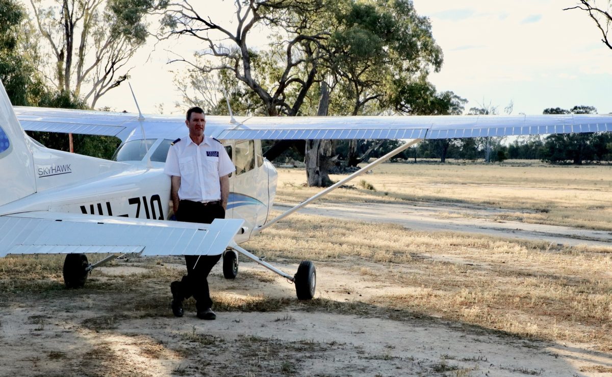 Man standing with cessna aeroplane