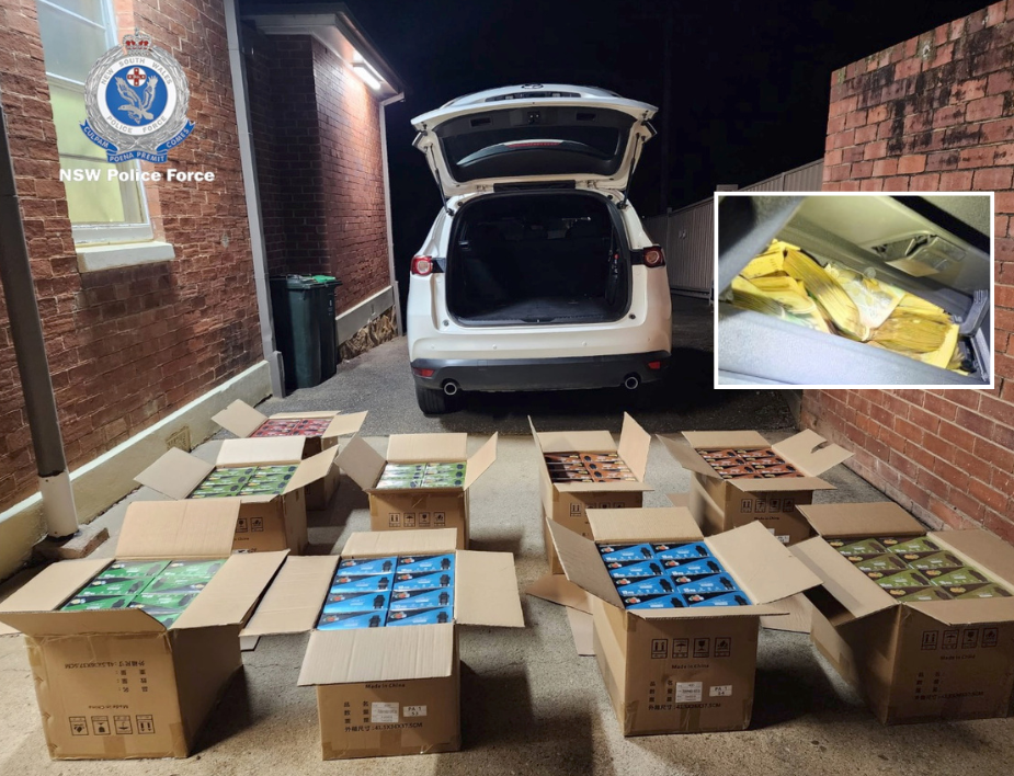 boxes full of illegal vapes in front of a car with its boot open