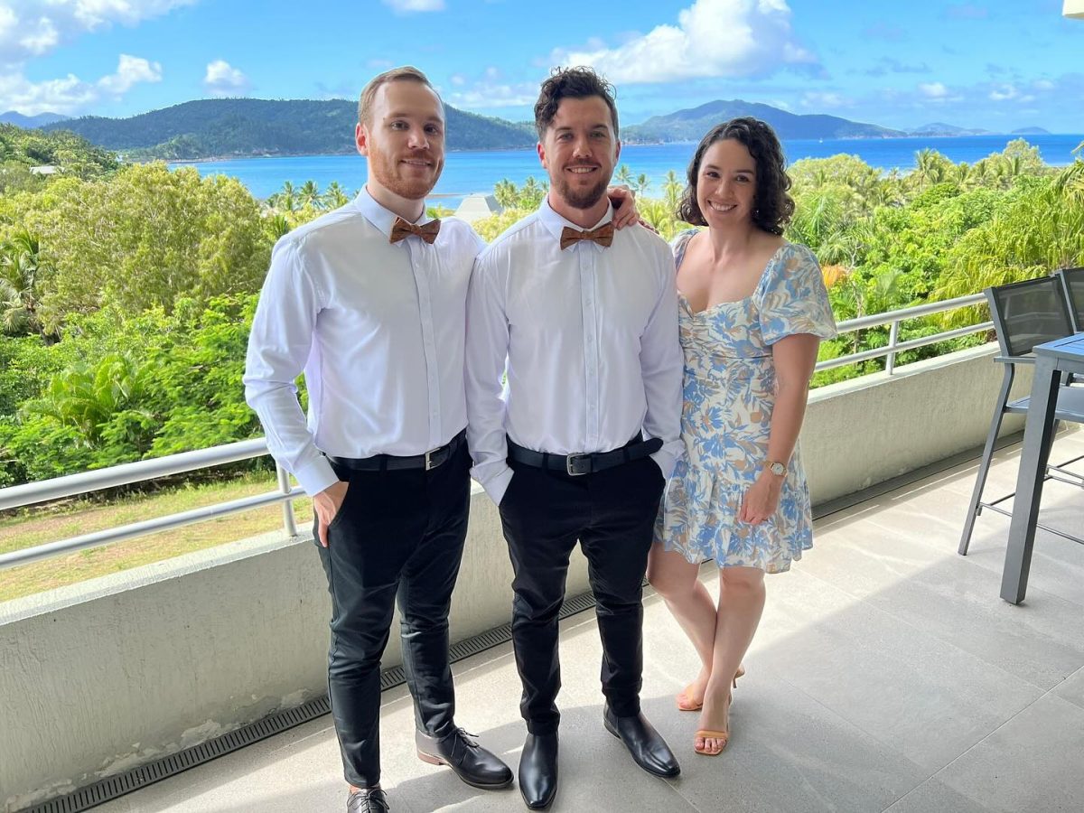 Three people on a balcony 