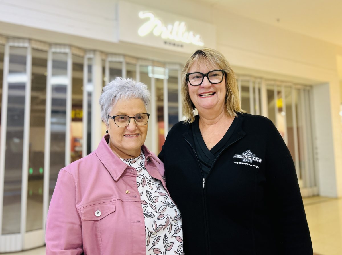 Two older women outside a women's boutique