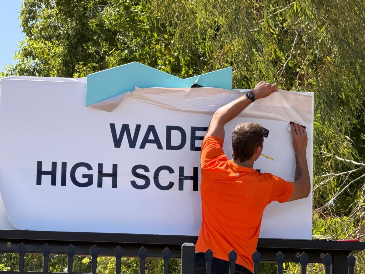 Guy puts up Wade High sign 